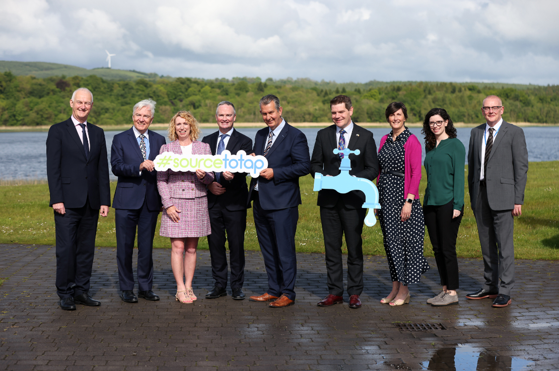 A group of TD's and Uisce Éireann board members holding a Source to tap sign