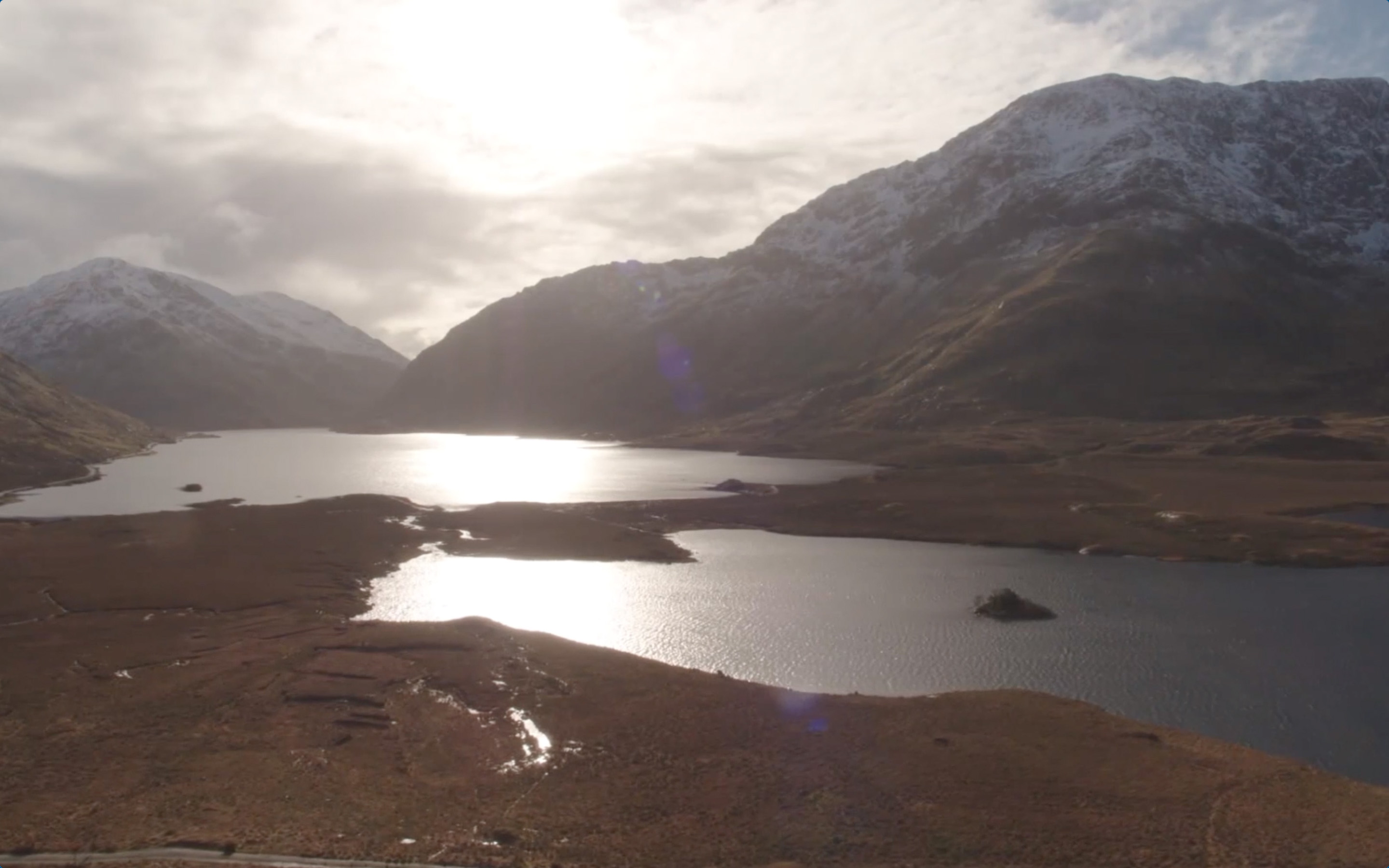 Two lakes in a valley with mountains covered in snow