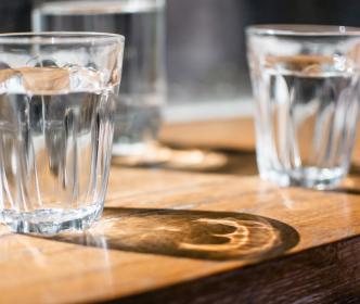 Close up of two glasses of water sitting on a table