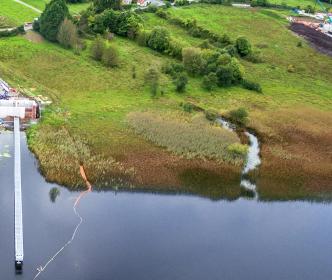 A group of people holding shovels and a sign reading "Safeguarding Our Environment"